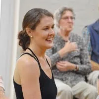 Carmen laughing with a class in a Napier hall